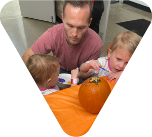 family painting pumpkins during Halloween at the South Oakland YMCA